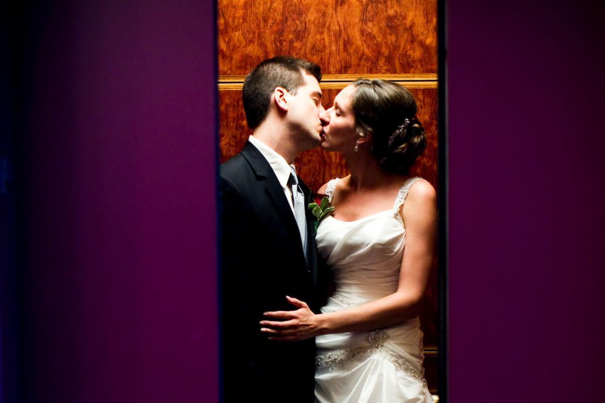 Beautiful Wedding Couple Kissing In The Elevator