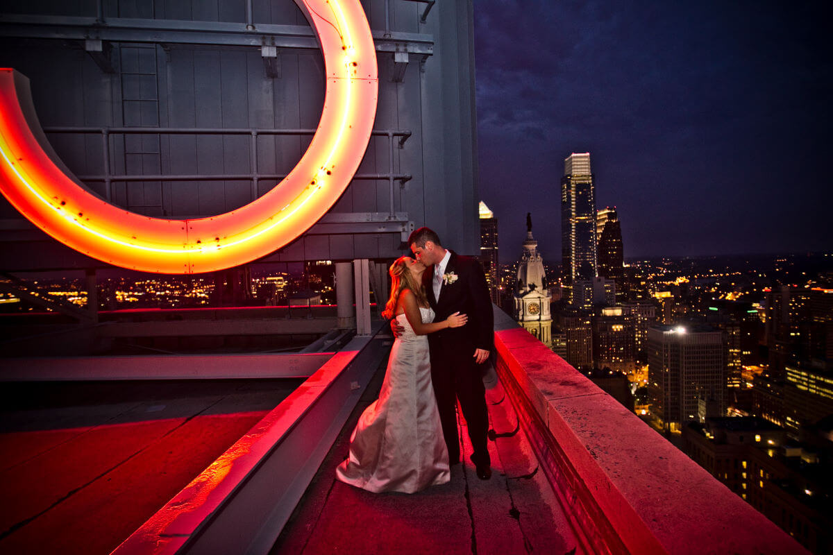 Gorgeous Wedding Couple Strike A Pose On Top Of The Majestic Building