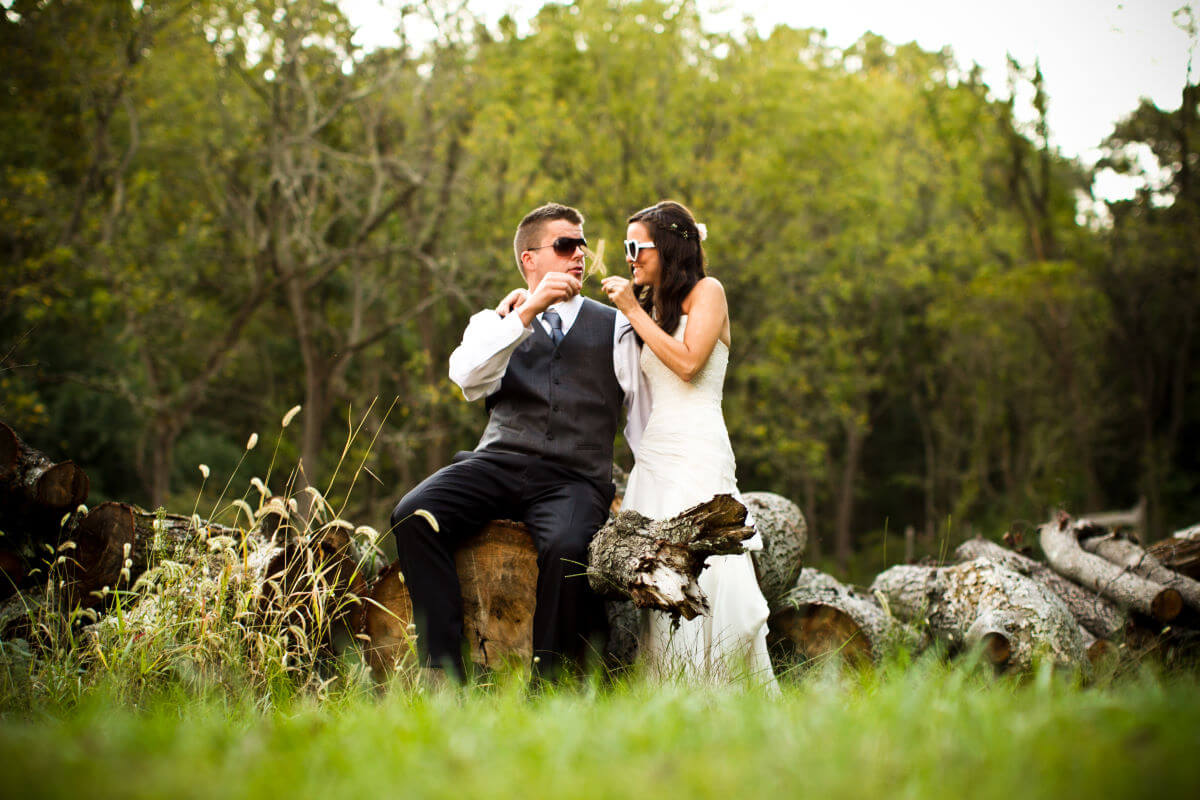 Smiling Bride And Groom Wearing Sunglasses