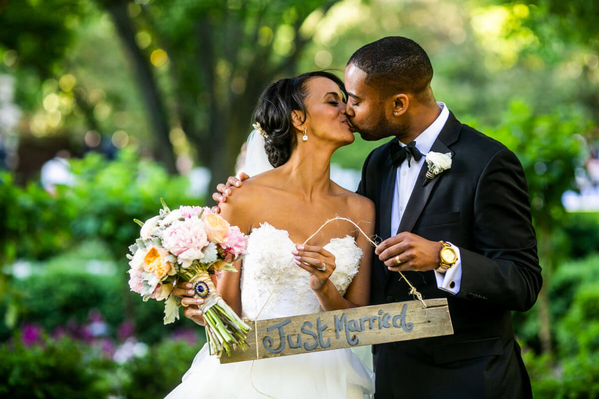 Wedding Couple From Philadelphia Kissing And Holding Just Married Sign